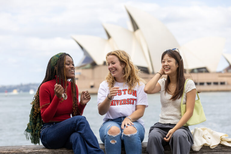 Three BU students are perched along the river in Sydnee abroad in Sydney, Australia. Photo by Daniel Boud for Boston University Photography.