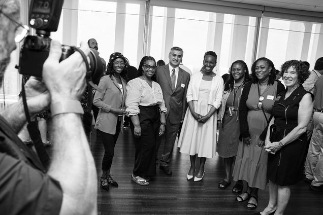President Melissa Gilliam posing for a photo with a group of Medical Campus staff