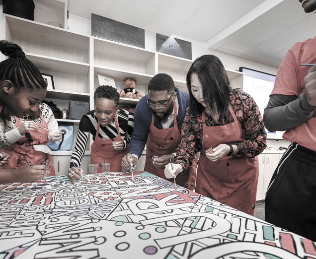 President Melissa Gilliam painting beside the Newbury Center's Faculty Director Anthony Abraham Jack and Executive Director Maria Dykema Erb
