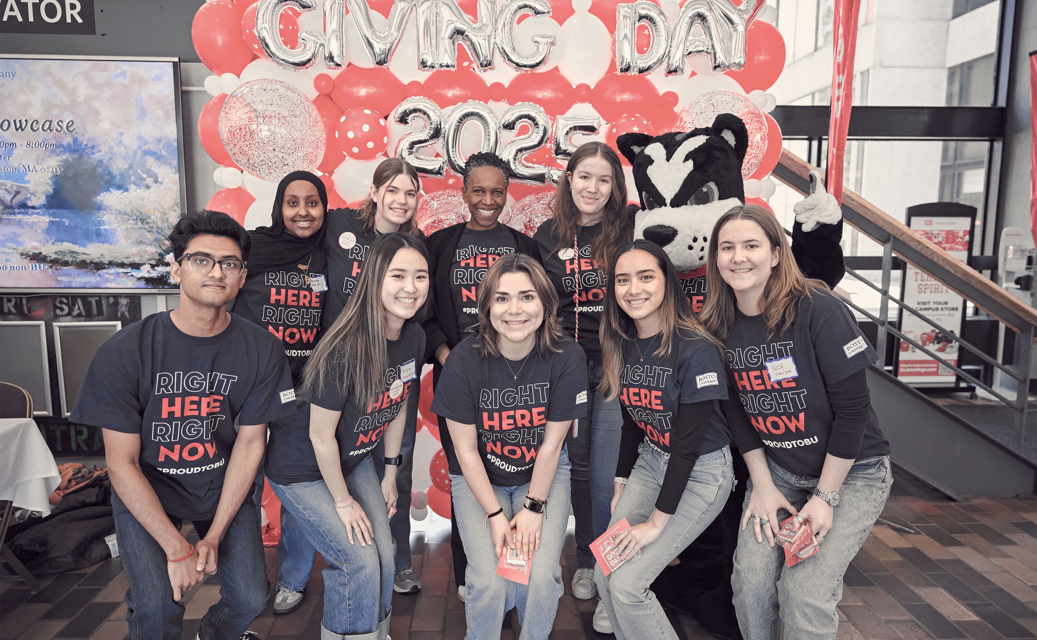 A group of students posing for a photo in front of a balloon arch with President Melissa Gilliam at Giving Day 2025